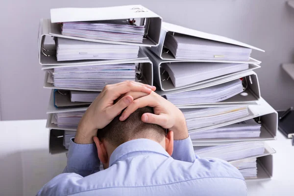 Rear View Stressed Businessman Hand Head Front Stacked Folders Stock Picture