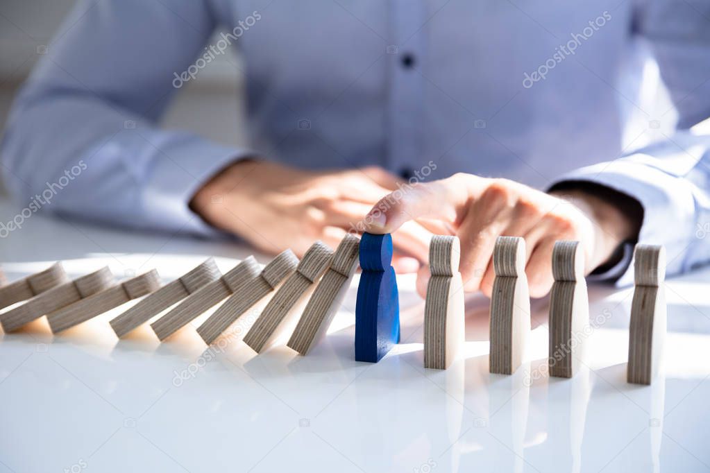 Close-up Of A Male Hand Stopping The Persons From Falling On Desk