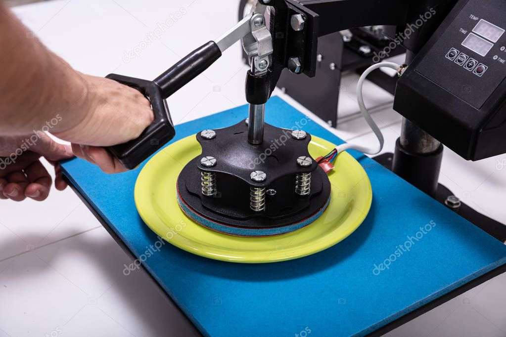 Man printing on plates  in workshop
