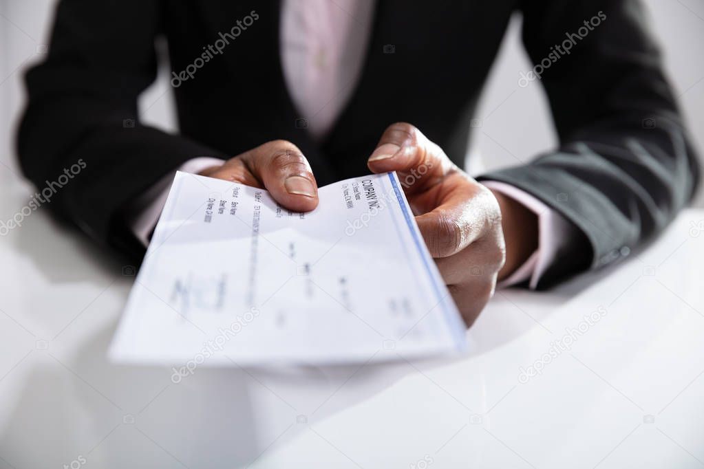 Photo Of Businesswoman Giving Cheque Over White Desk