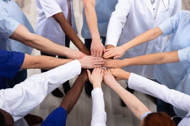Directly Above Shot Of Medical Team Stacking Hands Together At Hospital clipart