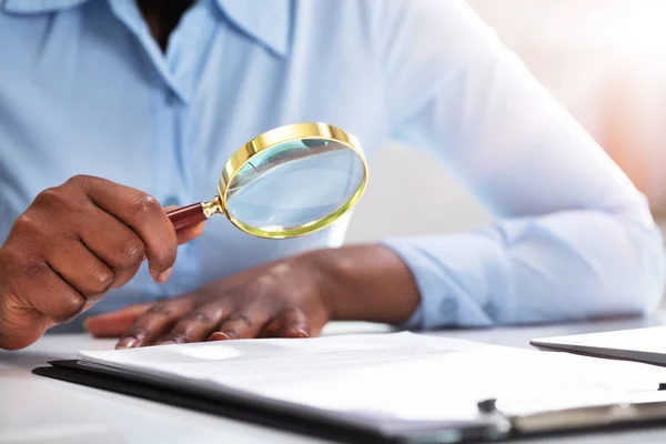 Close Businessperson Hand Looking Contract Form Magnifying Glass — Stock Photo, Image