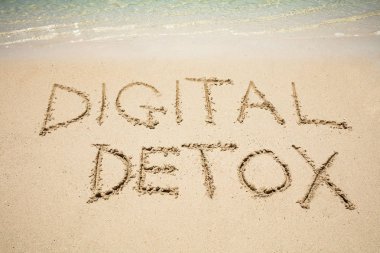 Digital Detox Word Written On Sand Near The Sea At Beach clipart