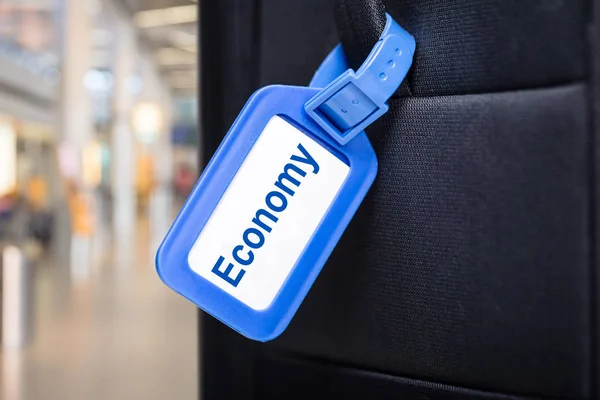 Close Van Economie Bagage Label Gebonden Aan Een Zwarte Koffer — Stockfoto