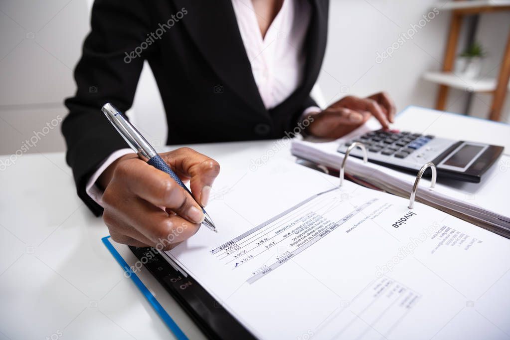 Photo Of Businesswoman's Hand Calculating Bill In Office