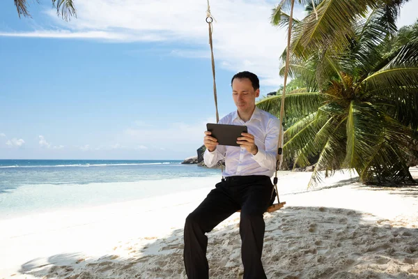 Homem Sentado Balanço Usando Tablet Digital Praia Areia Perto Mar — Fotografia de Stock