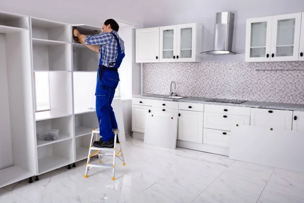 Rear View Serviceman Standing Ladder Fixing Cabinet Door Modular Kitchen — Stock Photo, Image