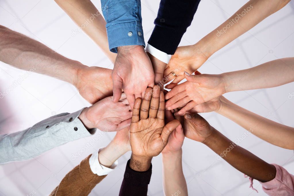 Multi-ethnic Group Of People Stacking Hand Showing Unity