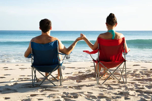 Rear View Young Couple Sitting Chairs Holding Each Other Hands — Stock Photo, Image
