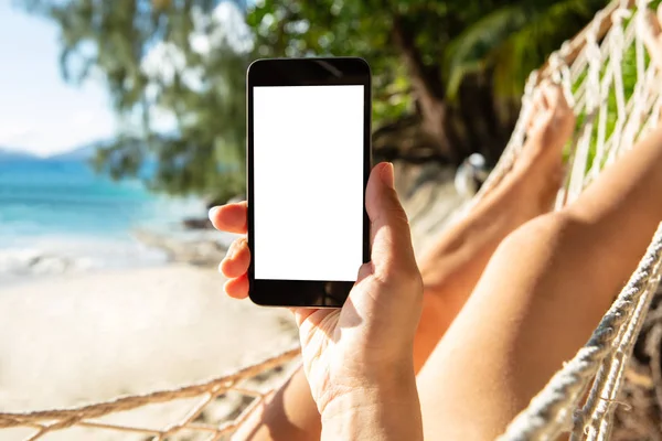 Woman Using Mobile Phone White Screen Display Lying Hammock Beach — 스톡 사진