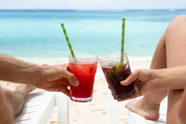 Couple Hands Toasting Juice Glasses Lying Deck Chair Beach — стоковое фото