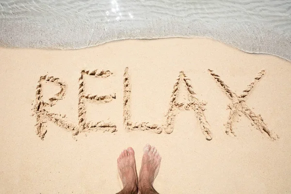 Person Foot Relax Text White Foamy Wave Written Sandy Beach — Stock Photo, Image