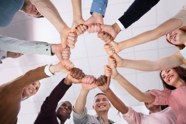 Multi-ethnic Group Of People  Holding Each Other Thumbs Forming Circle clipart