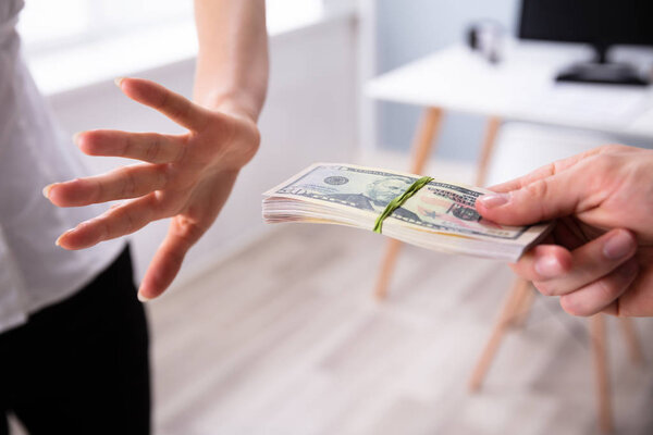 Close-up Woman's Hand Refusing To Take Bribe From Man