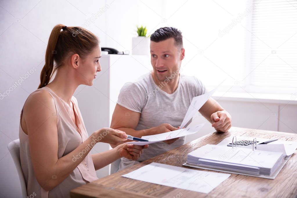 Young Couple Arguing About Expensive Invoice At Home