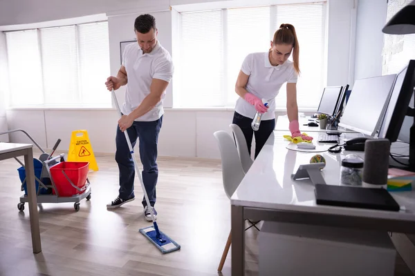 Two Smiling Young Janitor Cleaning Desk Mopping Floor Office — Stock Photo, Image