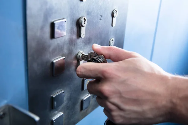 Close Human Hand Inserting Turning Key Unlock Elevator — Stock Photo, Image