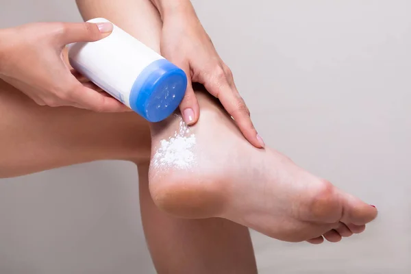 Close-up Of Woman Applying Powder To Her Skin