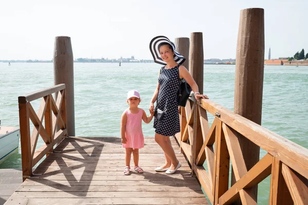 微笑的母亲和女儿在码头上摆姿势享受威尼斯的假期 — 图库照片