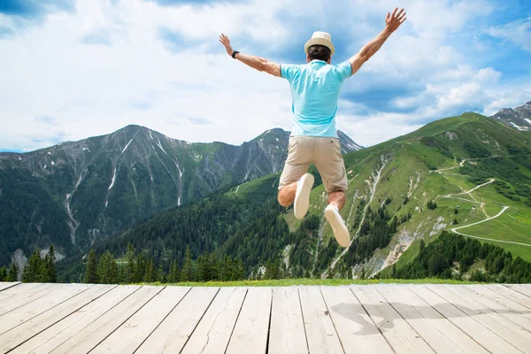 Happy Man Jumping In Austrian Mountains In Summer