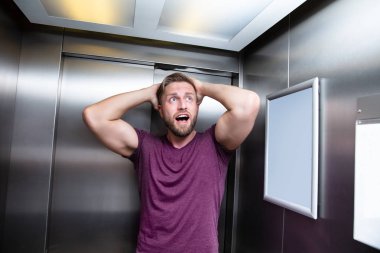 Man Suffering From Claustrophobia Trapped Inside Elevator Screaming clipart