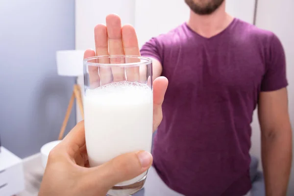 Close Man Rejecting Glass Milk Offered Person Home — Stock Photo, Image