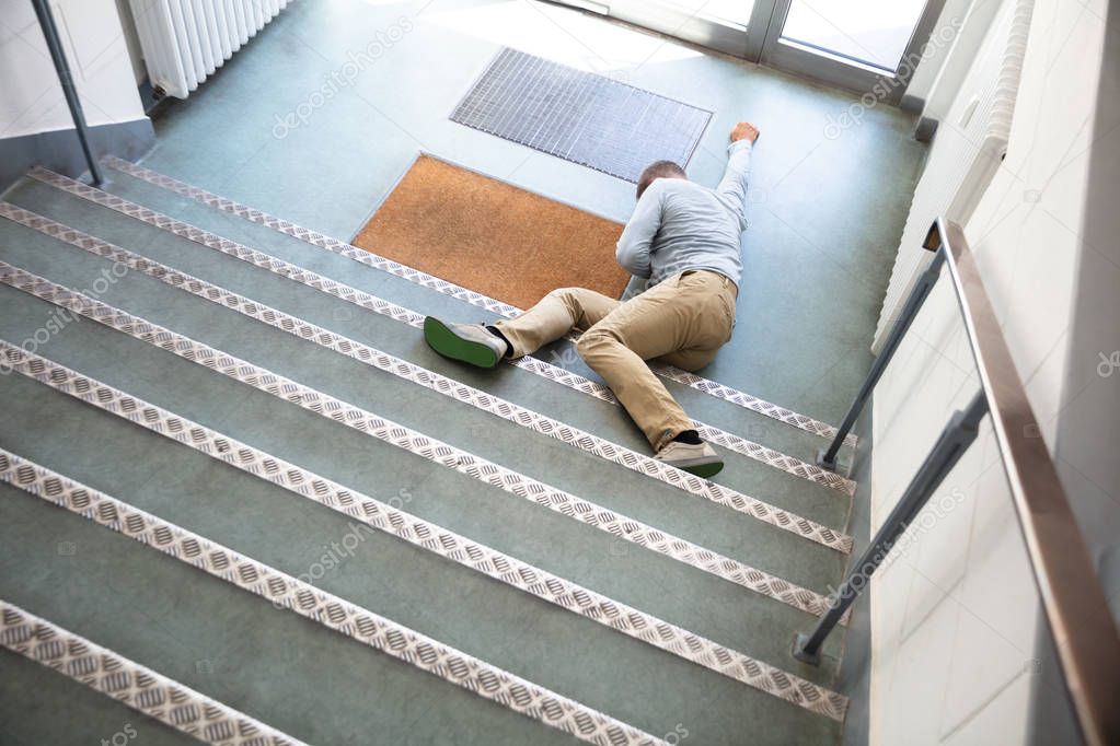 Unconscious Man Lying On Staircase After Slip And Fall Accident
