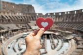 Man Holding Heart Shape Inside Of Colosseum, Italy