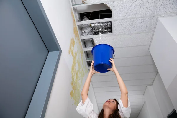 Mujer Preocupada Sosteniendo Cubo Azul Bajo Techo Fugas Corredor — Foto de Stock