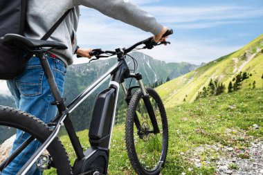 Main On Mountain With His Bike In Alps clipart
