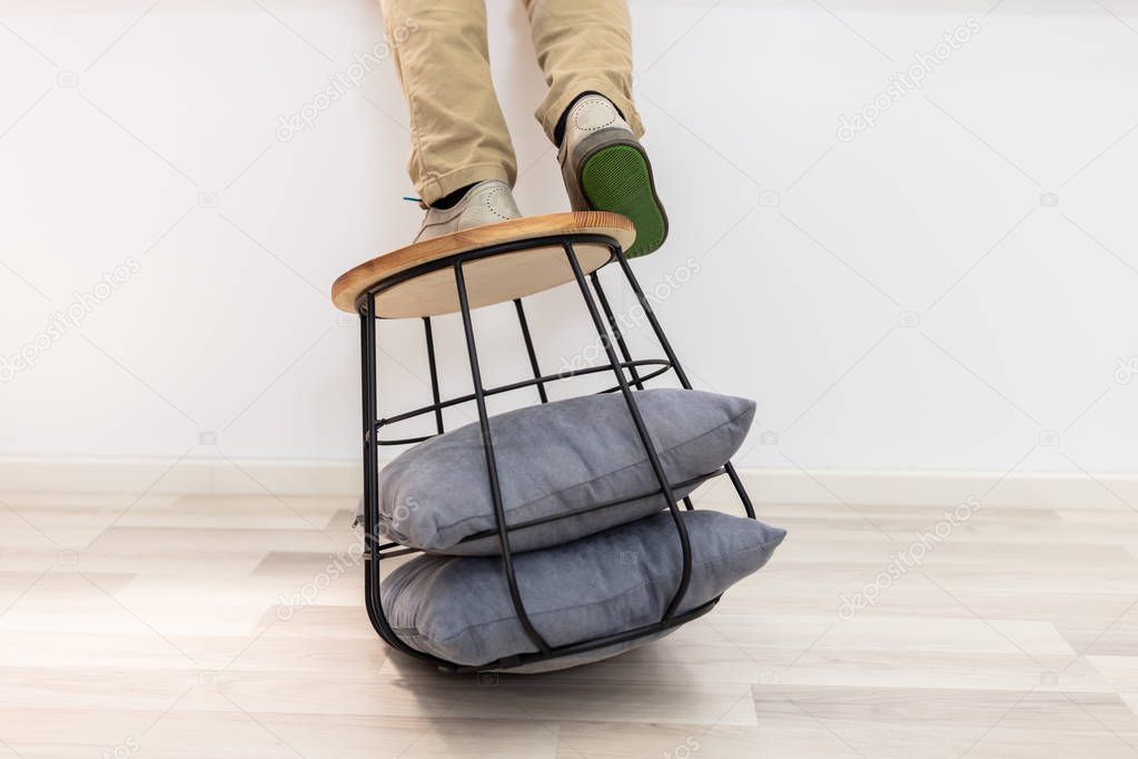 Man Standing On Sofa Table And About To Fall On Floor