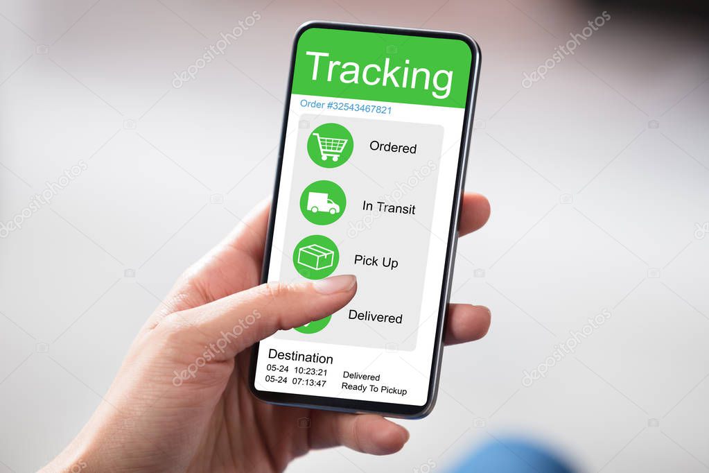 Customer Checking Shipment Tracking On Website On Smartphone Over White Desk