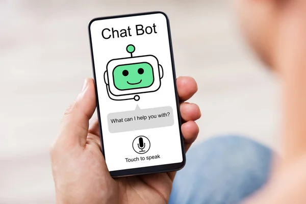 Close-up Of Man Using Chat Bot Application For Chatting On Smartphone