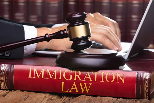 Male Judge Immigration Law Book Typing Laptop Front Gavel — Stock Photo, Image