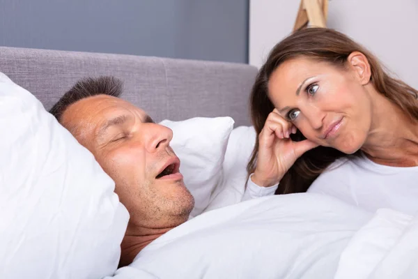 Angry Mature Woman Looking Man Snoring Bed Home — Stock Photo, Image