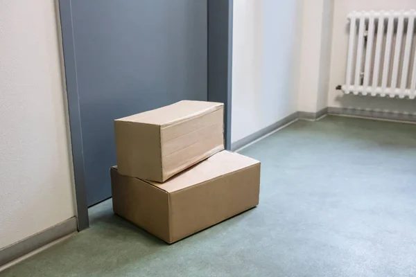 Close-up Of Cardboard Parcel Boxes Delivered Outside Front Door