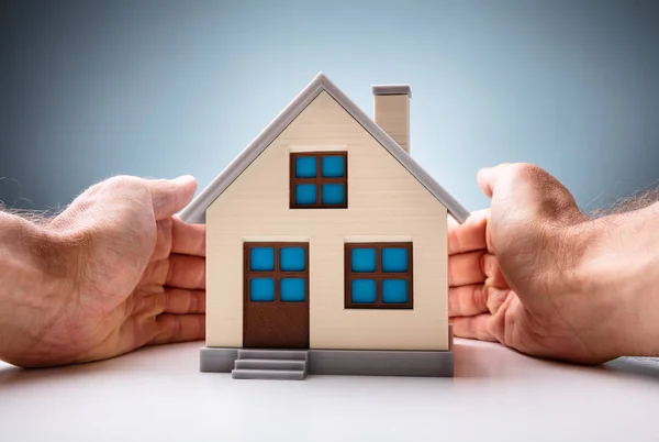 Close Man Hand Protect House Model White Desk — Stock Photo, Image