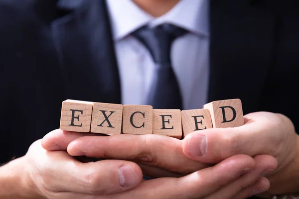 Businessman Holding Exceed Expectations Word His Hands — Stock Photo, Image