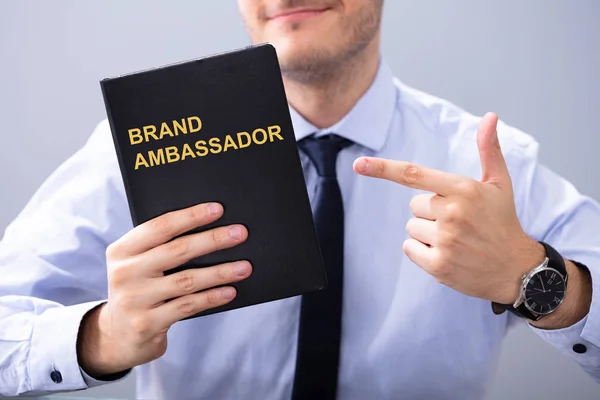 Man Holding Book Brand Ambassador Text Pointing — Stock Photo, Image