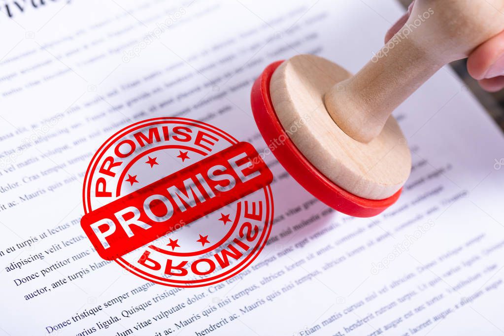 Businessman Hand Putting Promise Stamp On Document