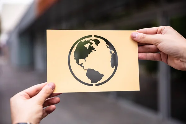 Hands Holding Paper With Cutout Planet Earth Outdoors