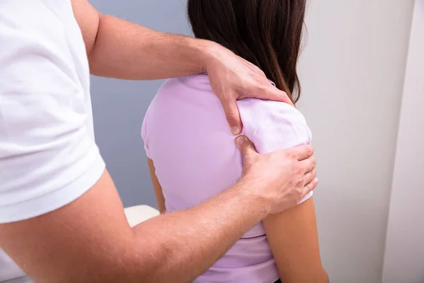 Professional Male Physical Therapist Massaging Injured Shoulder Woman Slowly Medical — Stock Photo, Image