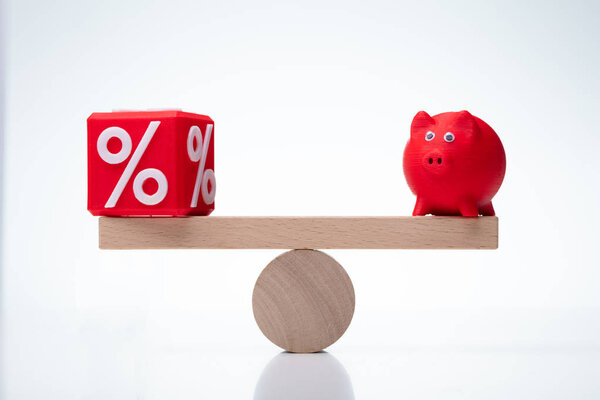 Seesaw Showing Balance Between Percentage And Piggybank