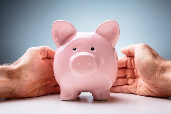 Midsection Businesswoman Protecting Piggybank Wooden Table — Stock Photo, Image