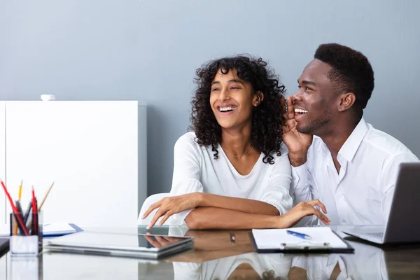 People Laughing About Their Coworker In Office