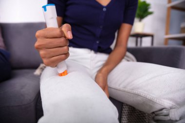 Woman Injecting Epinephrine Using Auto-injector Syringe As An Emergency Treatment For Allergic Reaction  clipart