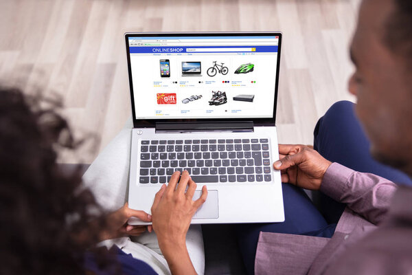 Couple Using Laptop For Shopping Online At Home