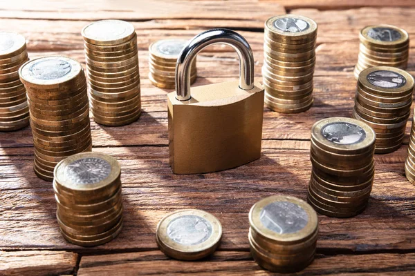 Metal Lock Surrounded Golden Stacked Coins Wooden Desk — Stock Photo, Image
