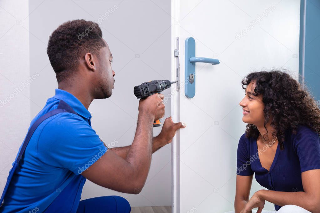 Technician Fixing The Door Lock At Clients Home