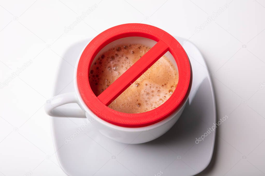 An Overhead View Of Red No Sign On Coffee Cup Over White Background
